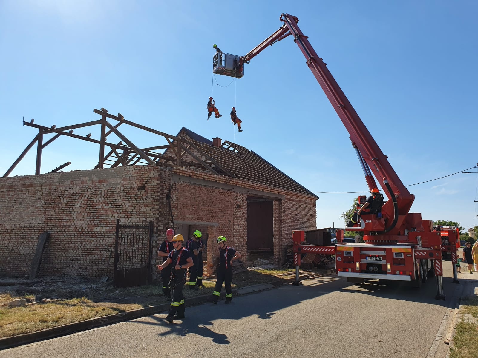 080 - někdy se hasiči na poničenou střechu nemohli dostat jinak než z výškové techniky.jpg